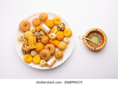 Group Of Indian Assorted Sweets Or Mithai With Diya