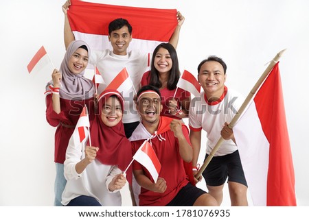 group of indonesian supporter celebrating victory together over white background. people holding flag during independence day of indonesia