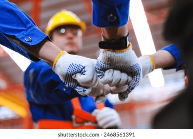 Group of industrial factory workers bumping fists together,showing gesture for teamwork or unity. - Powered by Shutterstock