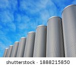 Group of industrial stained steel silos storage and a bright blue sky with clouds