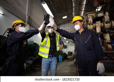 Group Of Industrial Technician Worker Giving High Five Or Raise Hands For Success The Project Together In Factory, New Normal Concept