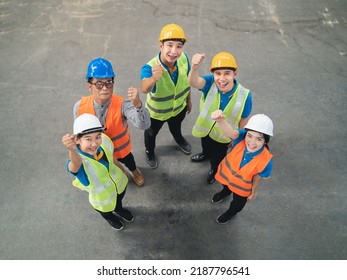 Group Of Industrial Warehouse Asian Worker In And Safety Suite Celebrating Or Raise Hands Pose Successful Or Deal Commitment. Logistics And Warehouse Business.Teamwork Unity Top View Concept.