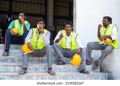 Group Of Industrial Workers Having Tea Or Coffee During Break - Concept Of Relaxation, Coworkers And Blue Collar Jobs