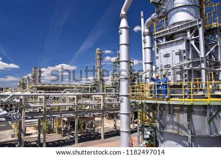 group of industrial workers in a refinery - oil processing equipment and machinery 
