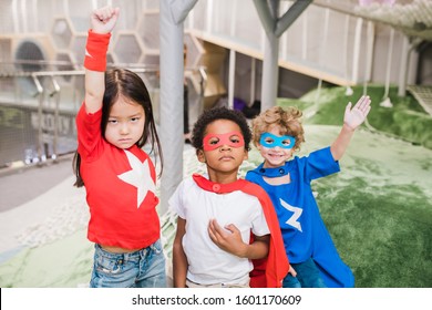 Group of intercultural children in attire of superheroes standing in front of camera during play in kindergarten - Powered by Shutterstock