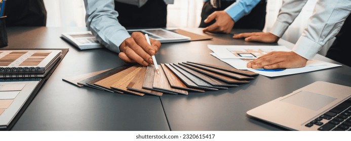 Group of interior designer team in meeting, discussing with engineer on interior design and planning for house project blueprint and model, choosing various mood board materials. Insight - Powered by Shutterstock