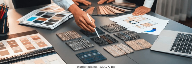 Group of interior designer team in meeting, discussing with engineer on interior design and planning for house project blueprint and model, choosing various mood board materials. Insight - Shutterstock ID 2321777185