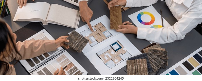 Group of interior designer team in meeting, discussing with engineer on interior design and planning for house project blueprint and model, choosing various mood board materials. Insight - Shutterstock ID 2322804245