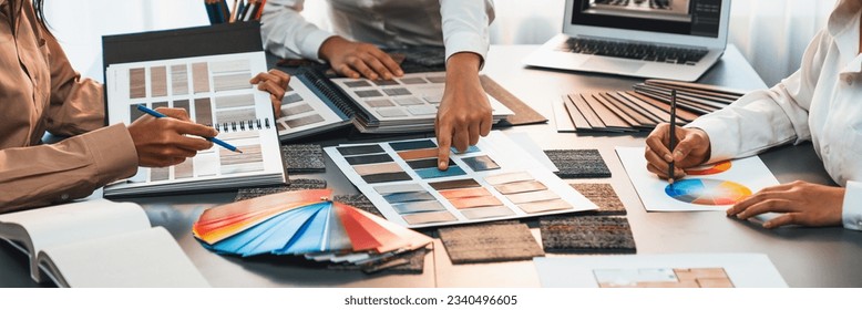 Group of interior designer team in meeting, discussing with engineer on interior design and planning for house project blueprint and model, choosing various mood board materials. Insight - Shutterstock ID 2340496605
