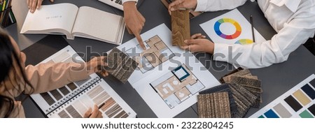 Group of interior designer team in meeting, discussing with engineer on interior design and planning for house project blueprint and model, choosing various mood board materials. Insight