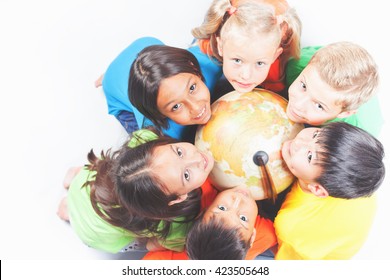 Group Of International Happy Kids Holding Globe Earth And Looking Up At Camera. School Children Learn Geography. Multi Ethnic People. World. Ecology. Pure Earth. International Children's Day