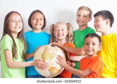 Group Of International Kids Holding Globe Earth. School Children Learn Geography. Multi Ethnic People. World. Ecology. Pure Earth.