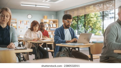 Group of International Mature Students Studying in Classroom. Modern Adult Training Center Help People to Develop New Useful Skills Throughout Life. Adults Writing in Notebooks and Using Computers - Powered by Shutterstock