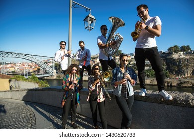 Group Of Jazz Musicians With Wind Instruments Playing On The Street.