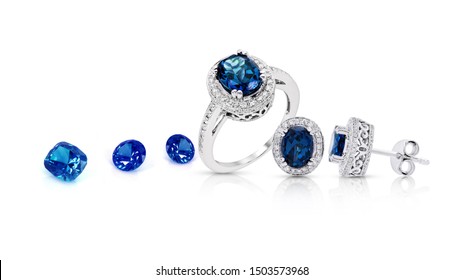 A group of jewelry consisting of sapphires, sapphire stones, sapphire earrings, sapphire rings arranged stacked on a white background