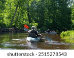 Group kayak trip for seigneur and senora . An elderly couple And adult rowing boat on the river, a water hike, a summer adventure. Age-related sports, mental youth and health, tourism, active old age