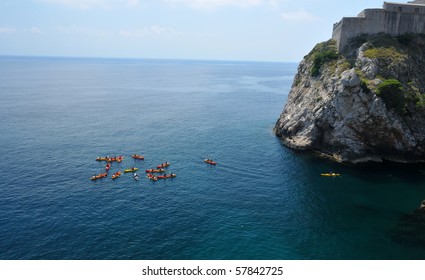 A Group Kayaking In The Mediterranean