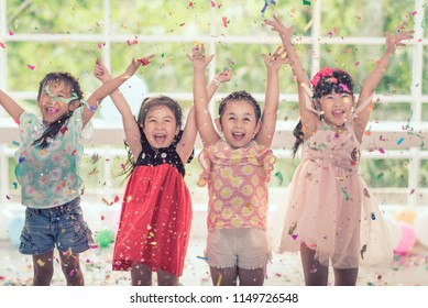 Group Of Kids Asian Celebrate Birthday Party Together. Birthday Party Little Girl Happy And Excited Confetti.  