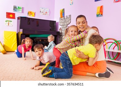 Group Of Kids Boys And Girls Hug Teacher