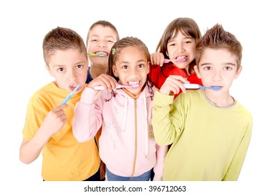 Group Of Kids Brushing Teeth Isolated In White