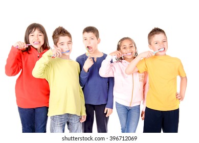 Group Of Kids Brushing Teeth Isolated In White