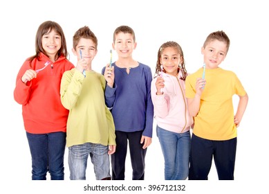 Group Of Kids Brushing Teeth Isolated In White