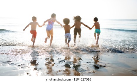 Group Of Kids Enjoying Their Time At The Beach