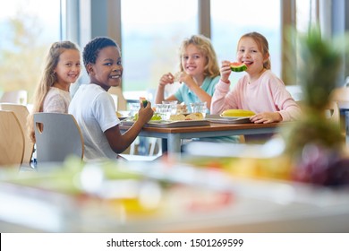 Group of kids as friends having lunch in school cafeteria - Shutterstock ID 1501269599
