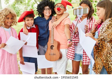 Group of kids in funny disguise takes a selfie after the summer camp talent show