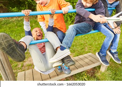 Group Of Kids Is Having Fun Climbing And Playing On A Jungle Gym In The Park