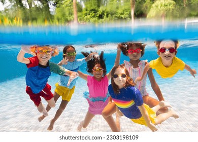 Group of kids jump into swimming pool. Summer water fun. Children play in outdoor pool. Summer family vacation with young kid. Holiday in tropical resort. Travel with child. - Powered by Shutterstock