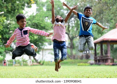 Group Of Kids Jumping On Grass, Happy Active Children Jumping