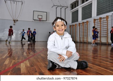 Group Of Kids Playing Basketball, Young Boy In Front Camera