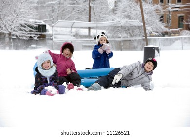 A Group Of Kids Playing In The Snow Outside And Having Fun