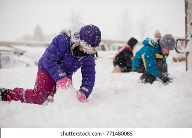 Group Of Kids Playing In The Snow In Winter Time