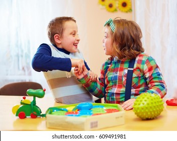 Group Of Kids Playing Together In Daycare Center For Kids With Special Needs