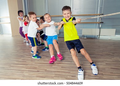 Group Of Kids Pulling A Rope In Fitness Room