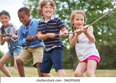 Group of kids pulling a rope at the park
