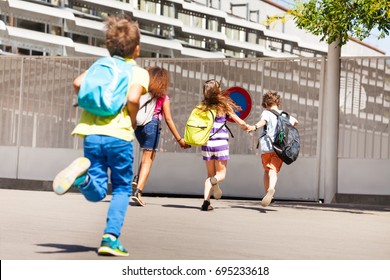 Group Of Kids Run To School One After Another