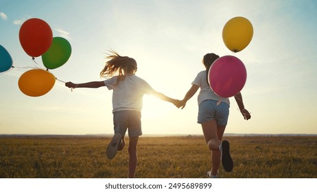 A group of kids are running around in nature with balloons. Happy family kid dream concept. A group of lifestyle children are running with. balloons. Group of kids running in nature with balloons. - Powered by Shutterstock