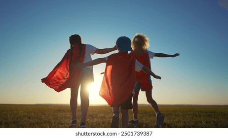 A group of kids are running around with superheroes. Hero super child concept. Group of lifestyle children running together, silhouette of. superheroes. A group of kids run together like superheroes. - Powered by Shutterstock