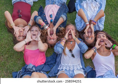 group of kids shouting or singing with cupped hands
