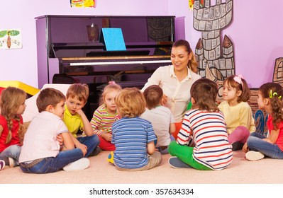 Group Of Kids Sit And Listen To Teacher Tell Story