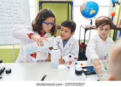 Group of kids students pouring liquid on bottl doing experiment at laboratory classroom - Powered by Shutterstock