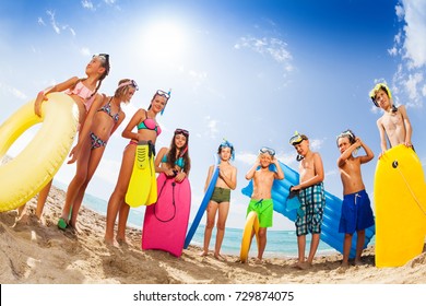 Group of kids in swim suits on the beach - Shutterstock ID 729874075
