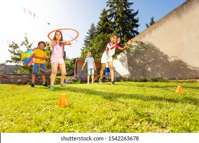 Group of kids throw hula rings to the target - Powered by Shutterstock