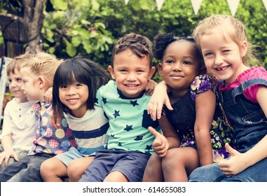 Group Of Kindergarten Kids Friends Arm Around Sitting And Smiling Fun