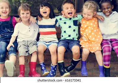Group of kindergarten kids friends arm around sitting and smiling fun - Shutterstock ID 616173341