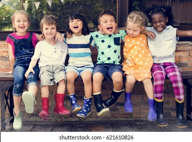 Group of kindergarten kids friends arm around sitting and smiling fun - Shutterstock ID 621610826