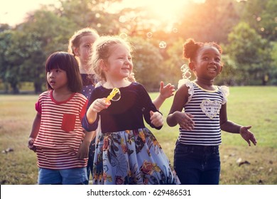 Group Of Kindergarten Kids Friends Playing Blowing Bubbles Fun